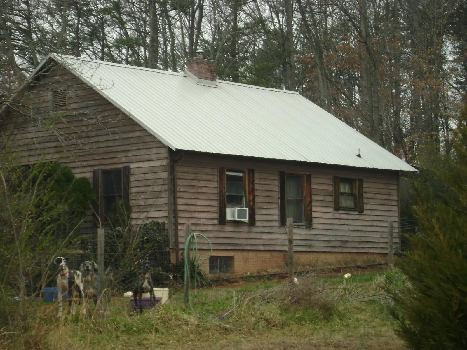 White metal roof on an old wood sided farmhouse, from a Metal Roof Installation job in Bosler